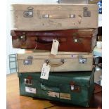 A group of four vintage suitcases.