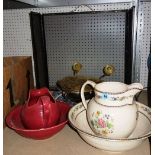 A floral decorated wash bowl and jug together with a red wash bowl and jug,