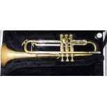 A 20th century trumpet, cased, together with a modern bagatelle board,