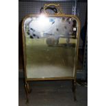 A 19th century brass framed bevelled glass fire screen of art nouveau design.