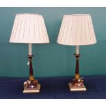 A pair of Georgian style mahogany table lamps, with fluted and gilt fluted columns on square bases,