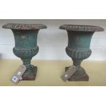 A pair of polychrome painted cast iron urns, early 20th century, of small proportions,