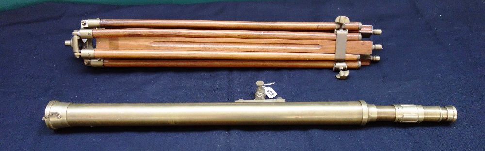 A reproduction brass cased telescope on a wooden adjustable tripod stand, the telescope 97cm.