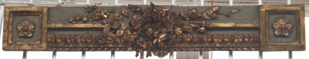 A painted and giltwood overdoor mantel, 19th century, carved and moulded with flowers and bows, 106.