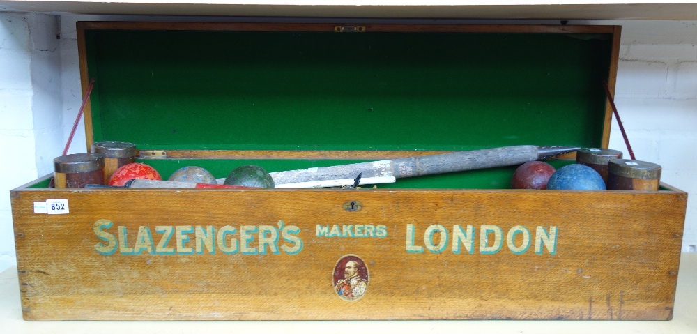 A Slazengers croquet set, circa 1905, comprising four mallets,