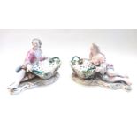 A pair of Meissen style porcelain figural sweetmeat dishes, late 19th century,