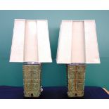 A pair of modern patinated table lamps of archaic Chinese form, each adjustable on a wooden base,
