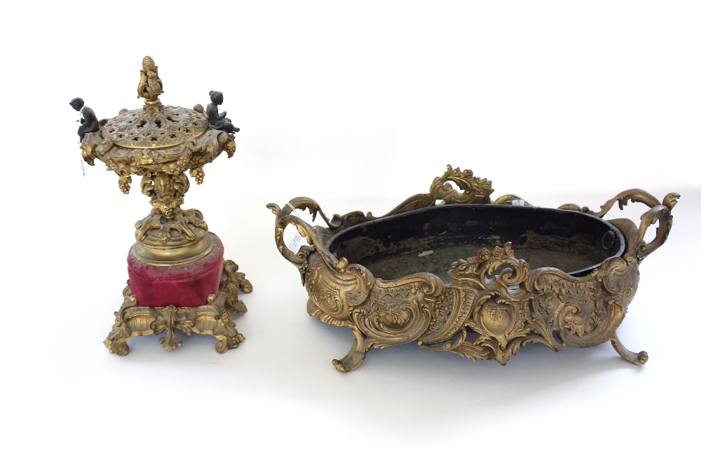 A French gilt bronze urn and cover, late 19th century, with foliate surmount and figural handles,