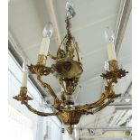 A Louis XV style gilt bronze five branch foliate cast chandelier, with cherub to the centre,