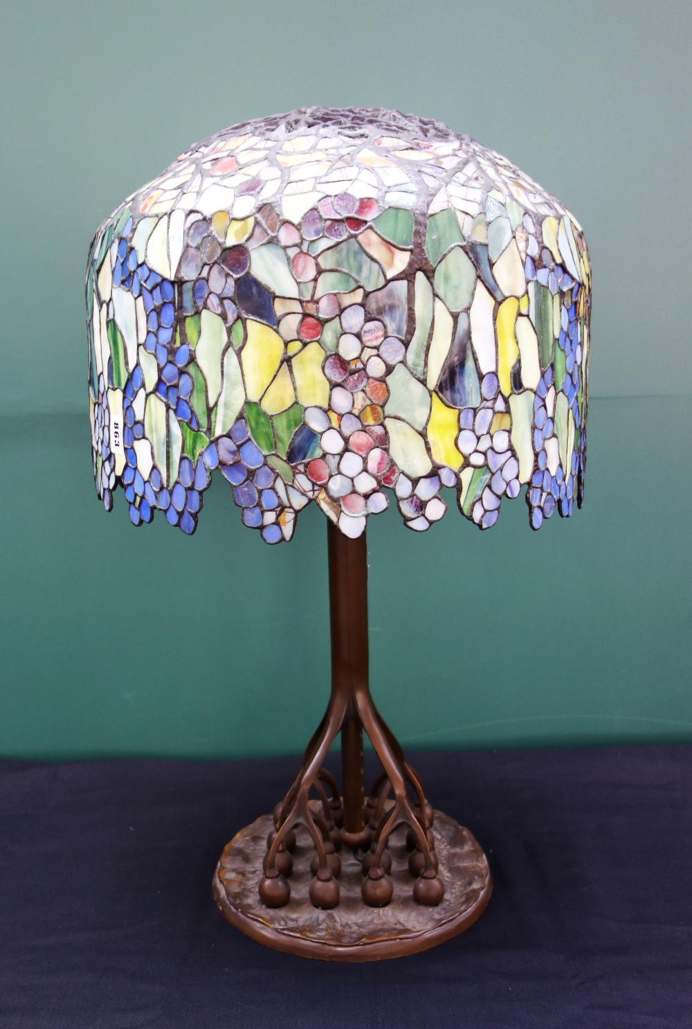 A bronze and coloured glass Tiffany style table lamp, late 20th century,