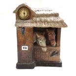 An Austrian terracotta mantel clock, circa 1900, relief cast with horses in a stable,