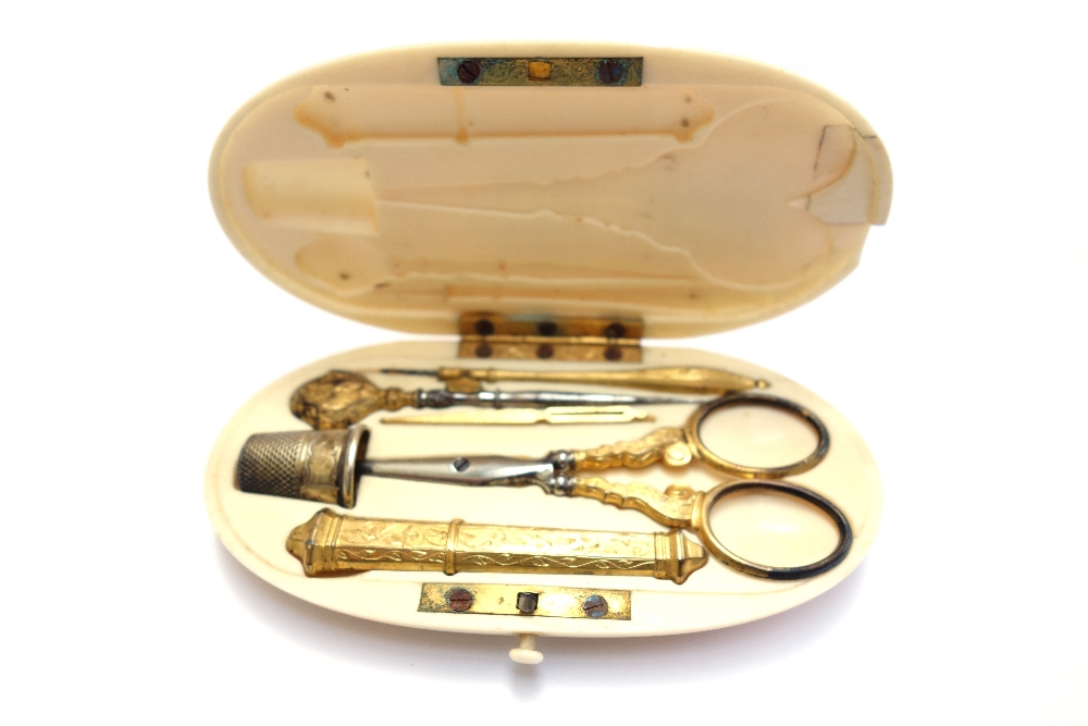 An ivory cased etui, 19th century, oval, monogrammed lid enclosing a gilt metal sewing set (11. - Image 3 of 3