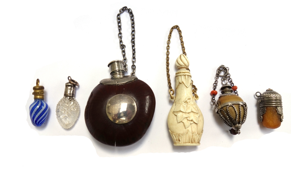 A novelty scent bottle made from a conker or similar nut, with white metal mounts, 5cm,