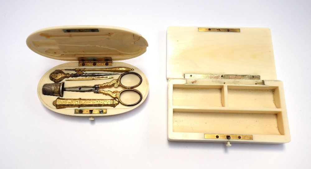 An ivory cased etui, 19th century, oval, monogrammed lid enclosing a gilt metal sewing set (11.