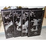 A group of four 20th century Oriental black lacquer and mother of pearl inlaid panels.