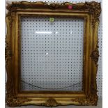 A 19th century gilt plaster swept frame, aperture 61.5cm x 53cm.