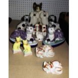 A quantity of ceramic animals, including Staffordshire spaniels, Oriental cats and sundry.