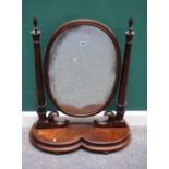 A large early Victorian figured walnut swing frame toilet mirror,