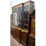 A George III style mahogany breakfront bookcase cupboard, with four astragal glazed doors,