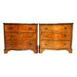 A pair of mid 18th century style serpentine walnut chests of three long graduated drawers,