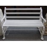 A white painted aluminium Coalbrookdale design garden bench, with dog's head finials and paw feet,