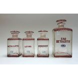 A set of four ruby flashed etched glass toiletry bottles and stoppers,