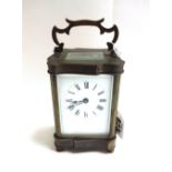 A brass cased carriage clock, late 19th century, with shaped case,