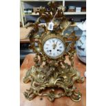 A French gilt bronze mantel clock, late 19th century, of Rococo scroll form,