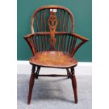 A George III yew and elm child's Windsor chair, with Prince of Wales carved splat and solid seat,