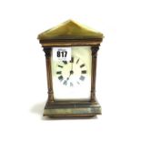 An onyx mounted brass cased carriage clock, early 20th century, with apex top and enamelled dial,