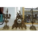 An early 20th century brass and marble mounted clock garniture,