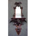 A 19th century Black Forest carved wood hall mirror, with bird crest and lower frieze,