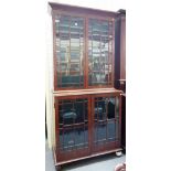 A 19th century double height bookcase with two pairs of square moulded astragal glazed doors,