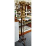 A pair of wrought iron and painted timber five light standing candelabra,