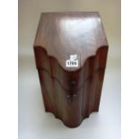 A George III mahogany slope front knife box, with serpentine lid and original fitted interior,