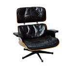 Charles Eames, a pair of laminated rosewood black leather upholstered easy armchairs,