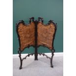 A late 19th century rococo revival carved mahogany two fold fire screen, 114cm wide x 134cm high.