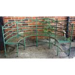 A Regency design green painted metal semi-elliptic garden bench, with slatted decoration,