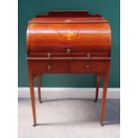 An Edwardian inlaid mahogany cylinder bureau, the fitted interior over two frieze drawers,