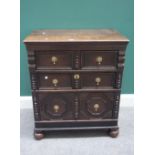 A 17th century and later small oak chest of three long graduated drawers,