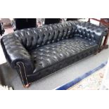A Victorian later studded black leather upholstered button back Chesterfield sofa,