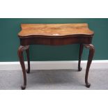 A mid 18th century mahogany card table, with serpentine foldover top and concertina action,
