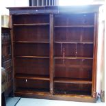 A 19th century mahogany floor standing twin section open bookcase with triple turned column