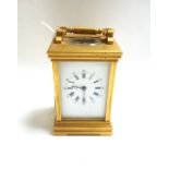 A gilt brass cased carriage clock, 20th century, the white enamel dial detailed with Roman numerals,