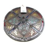 A Victorian stained glass circular panel of foliate geometric design,