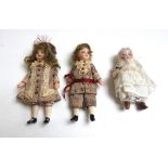 Three Continental miniature bisque head dolls, early 20th century, in period dress, unsigned,