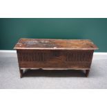A late 17th century oak five plank coffer, with carved lunette front panel, on slab end supports,