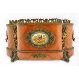 A 19th century French gilt metal and ceramic mounted kingwood jardiniere of serpentine outline,