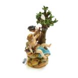 A Meissen figure group, late 19th century, modelled with Cupid sharpening his arrows on a wheel,