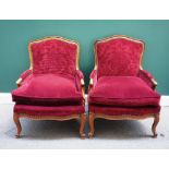 A pair of Louis XV style walnut framed fauteuils,